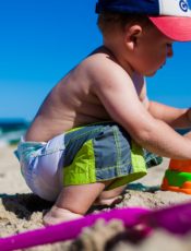 Boy playing with sand at Beach.