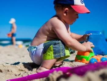 Boy playing with sand at Beach.