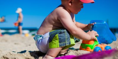 Boy playing with sand at Beach.